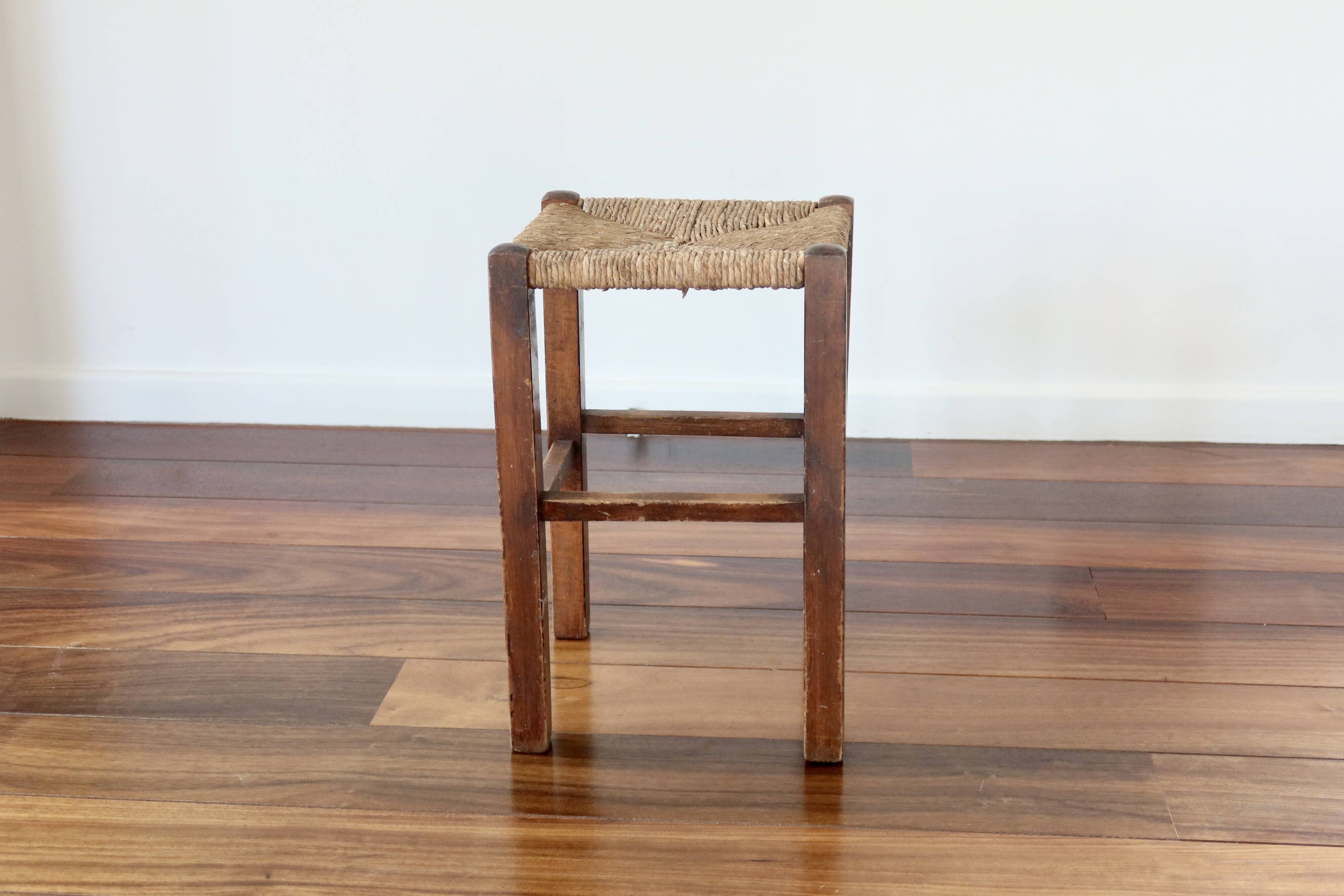 Rustic old stool made of wood and straw.
