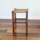 Rustic old stool made of wood and straw.