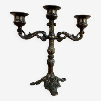 Old bronze-colored 3-branched candlestick