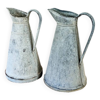 Set of two vintage zinc pitchers