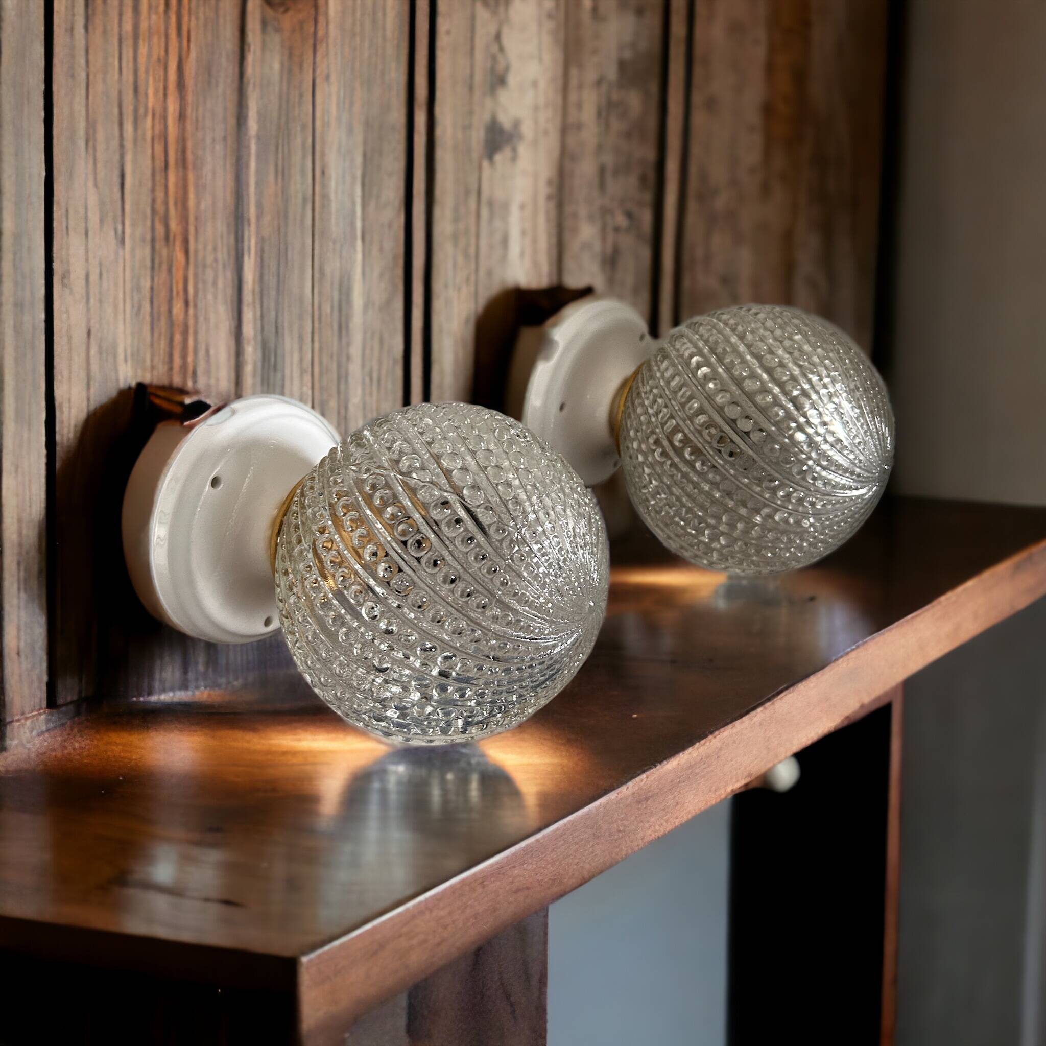 Set of two chiseled glass globe wall lights