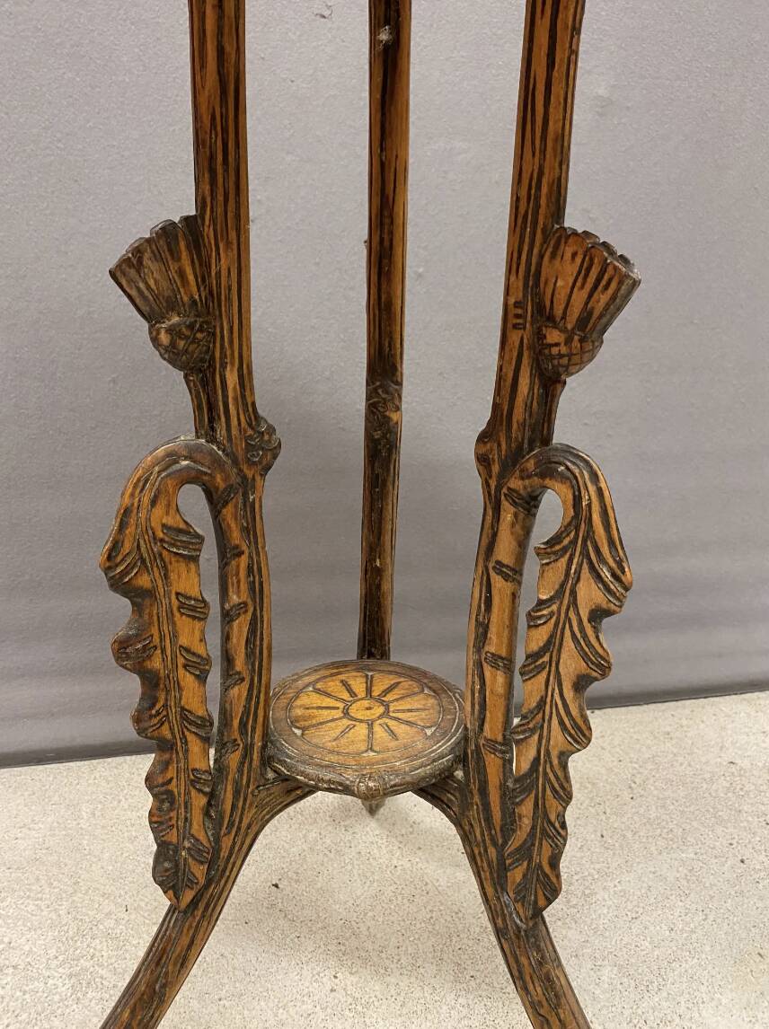 Carved wooden pedestal table