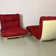 Vintage red shell lounge chairs from the 70s mid-century retro.