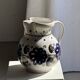 Very large vintage ceramic carafe in white glazed with blue floral decoration.