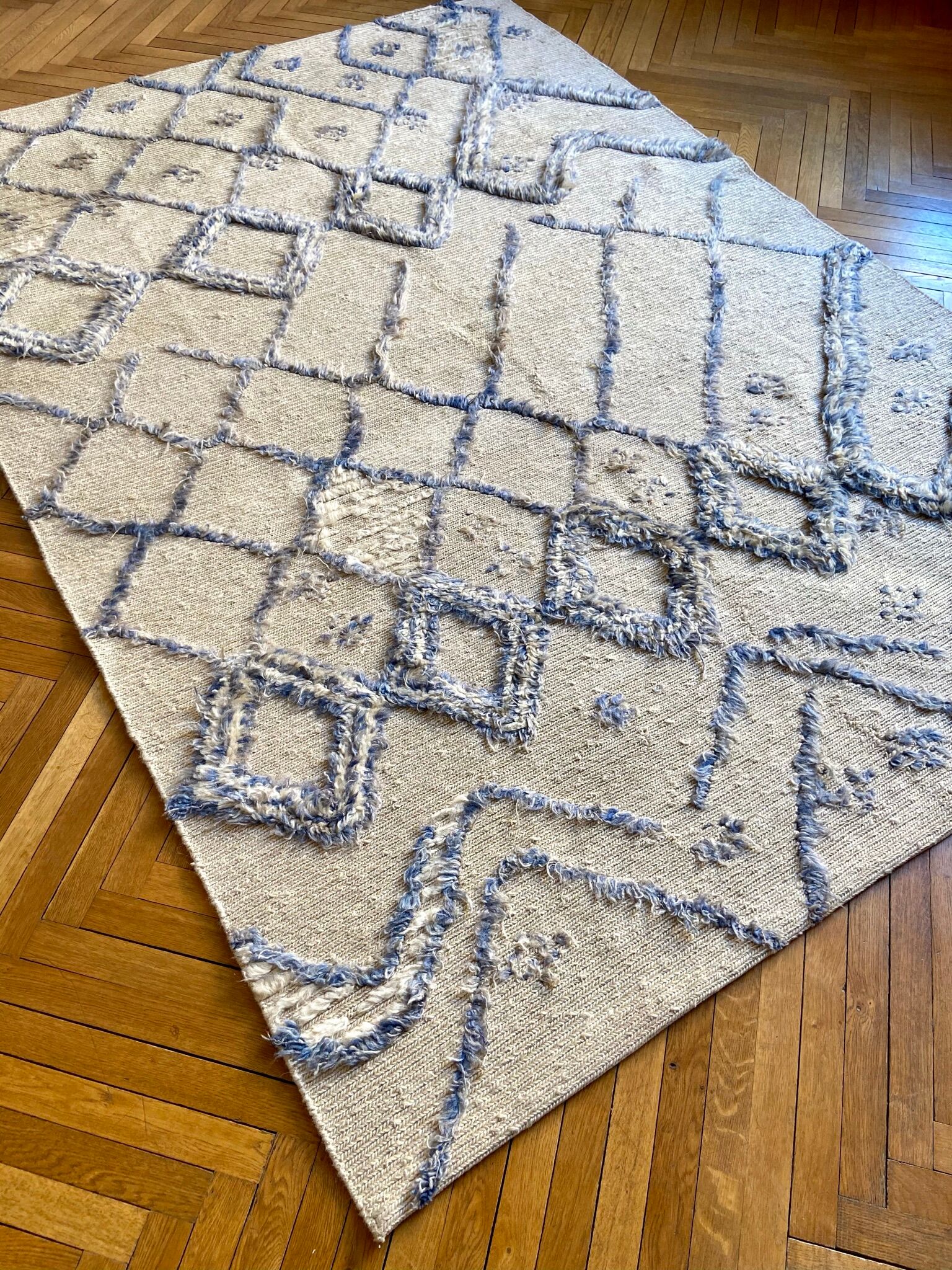 Berber cream carpet with blue patterns