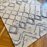 Berber cream carpet with blue patterns