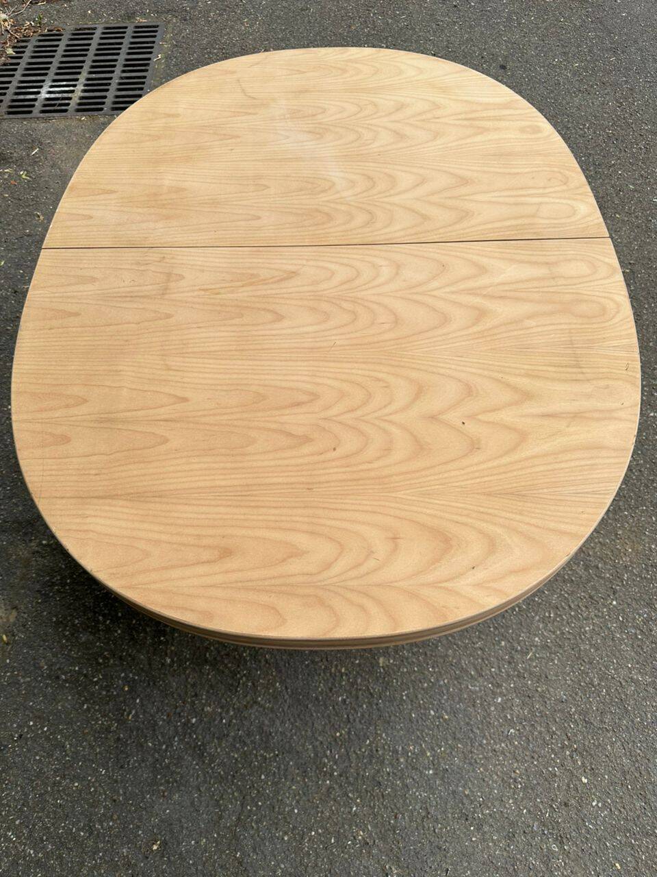 Renovated oval Scandinavian extendable dining table in wood with a central leg.