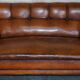 Victorian Chesterfield leather canapé with oak lion claw feet.