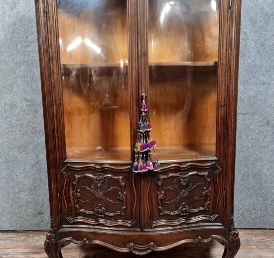 Curved library with two walnut doors, in Louis XV style.