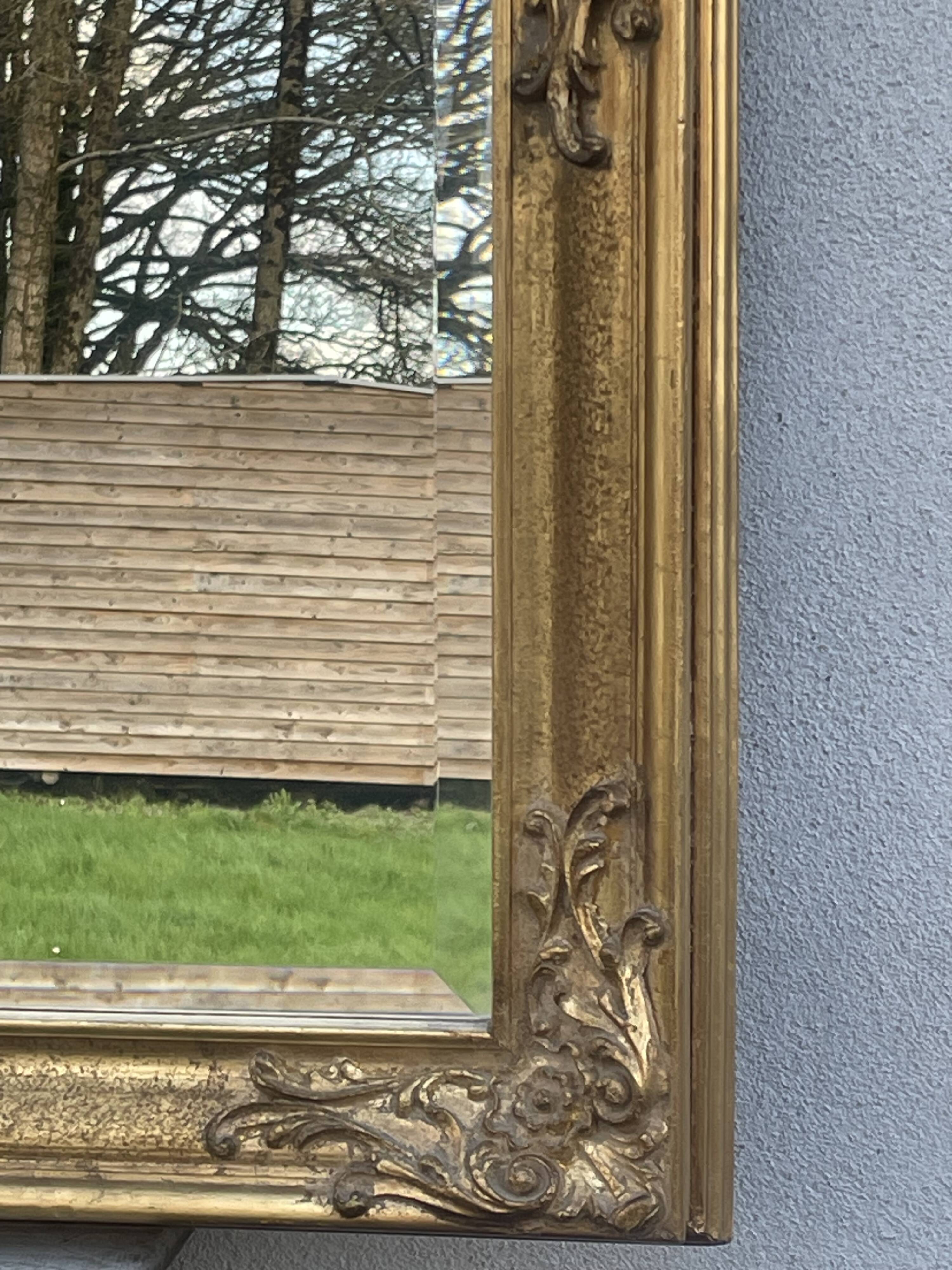 vintage bevelled mirror in rectangular shape, stucco and gilded wood in Louis XV baroque style