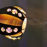Hanging lamp in thin metal pieces, copper colored and black with prisms.
