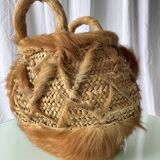 Handwoven vintage basket with handles made from natural fibres.