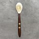 Mother-of-pearl and wood spoon
