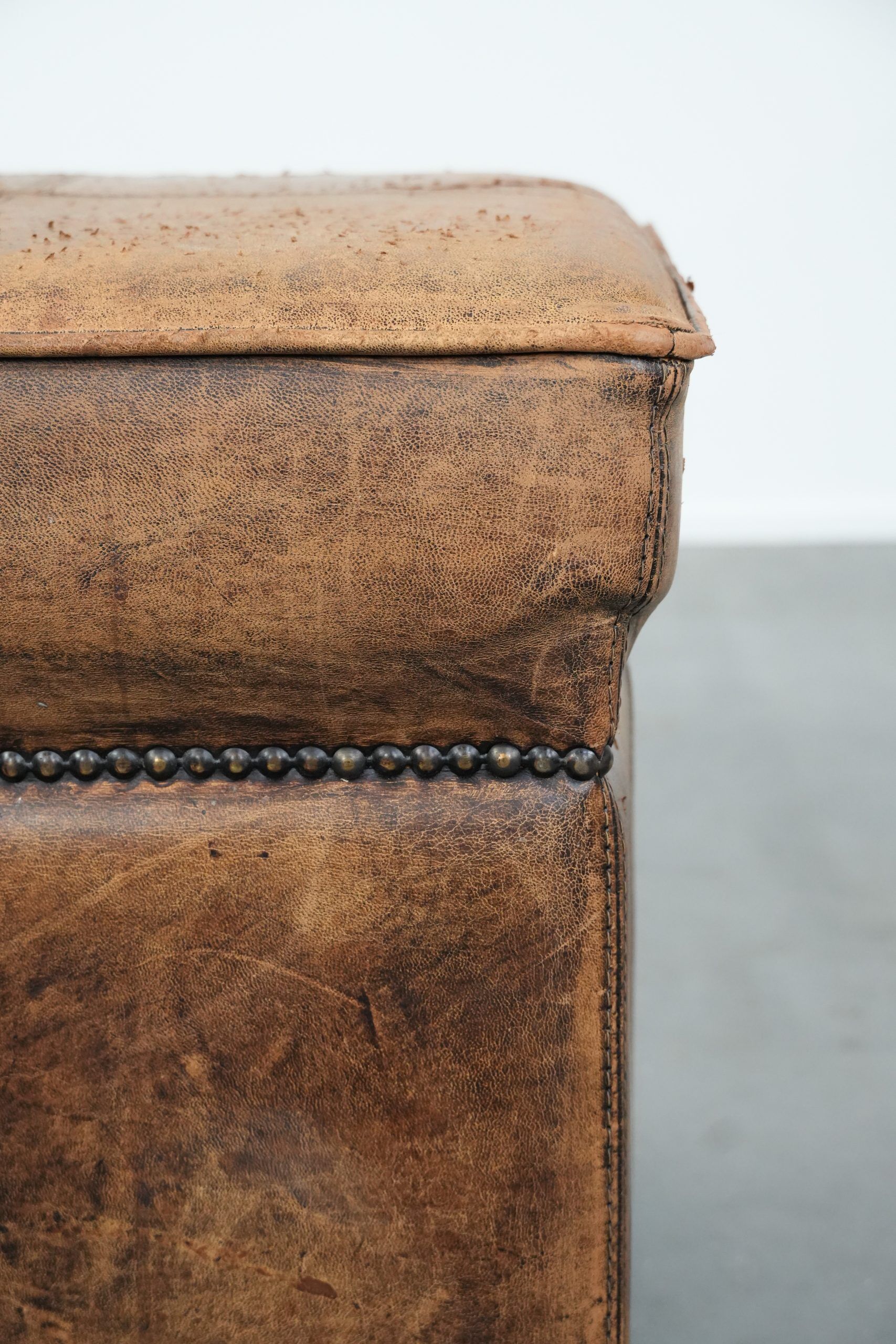 Sturdy square vintage sheepskin pouf/ottoman with beautiful colours