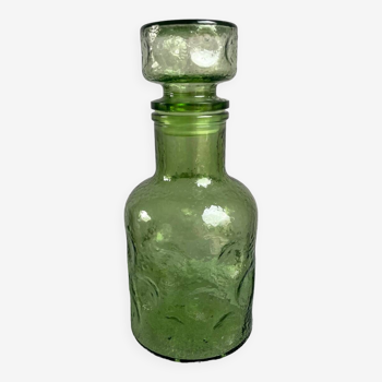 Green glass bottle with craters