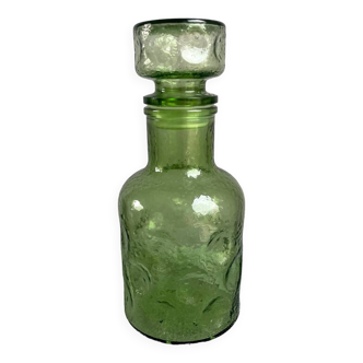 Green glass bottle with craters