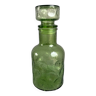 Green glass bottle with craters