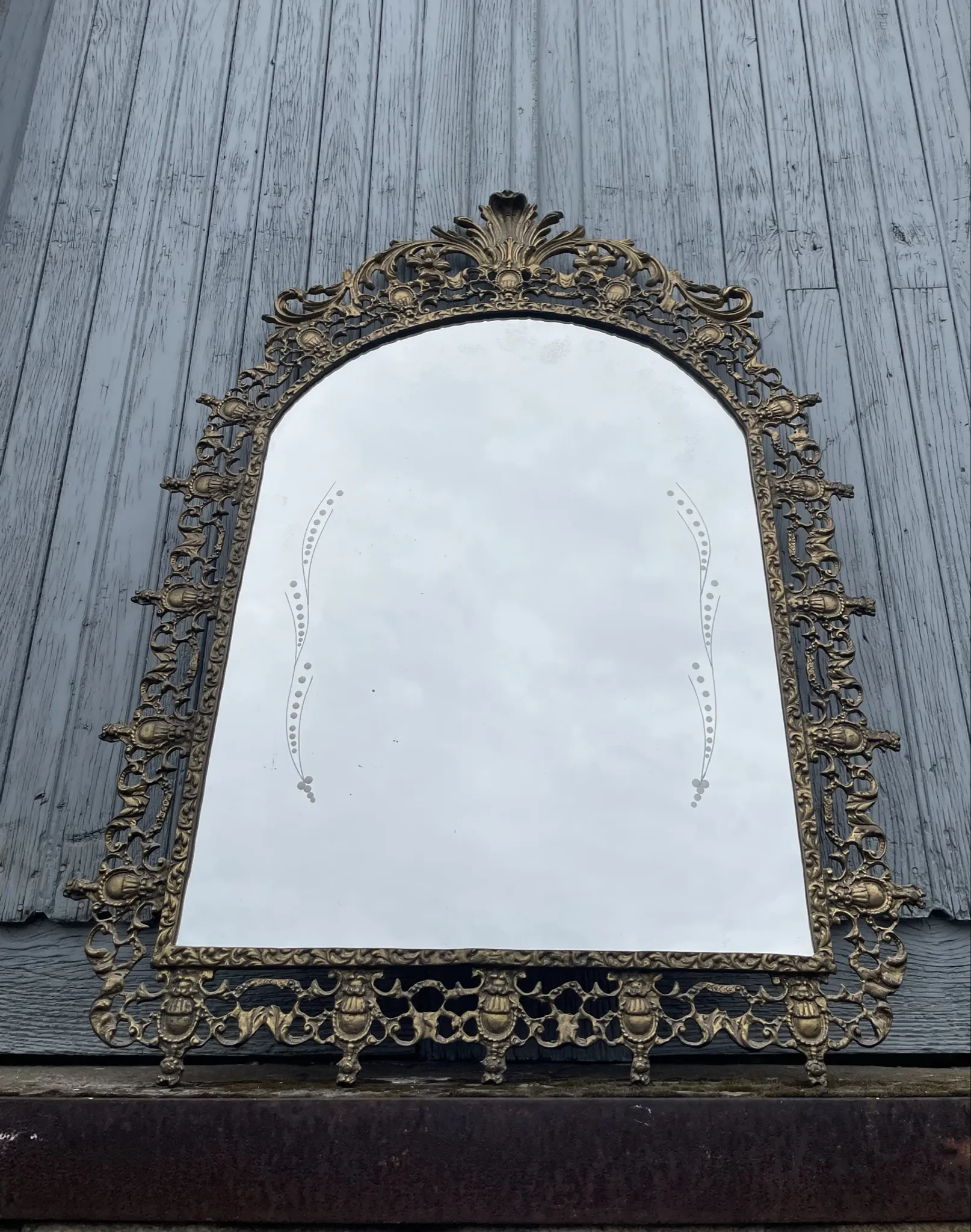 Vintage brass wall mirror adorned