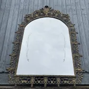 Vintage brass wall mirror adorned