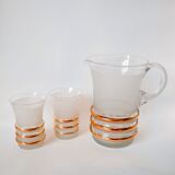 set composed of a pitcher and two large white granite glasses with gold edging from the 60s