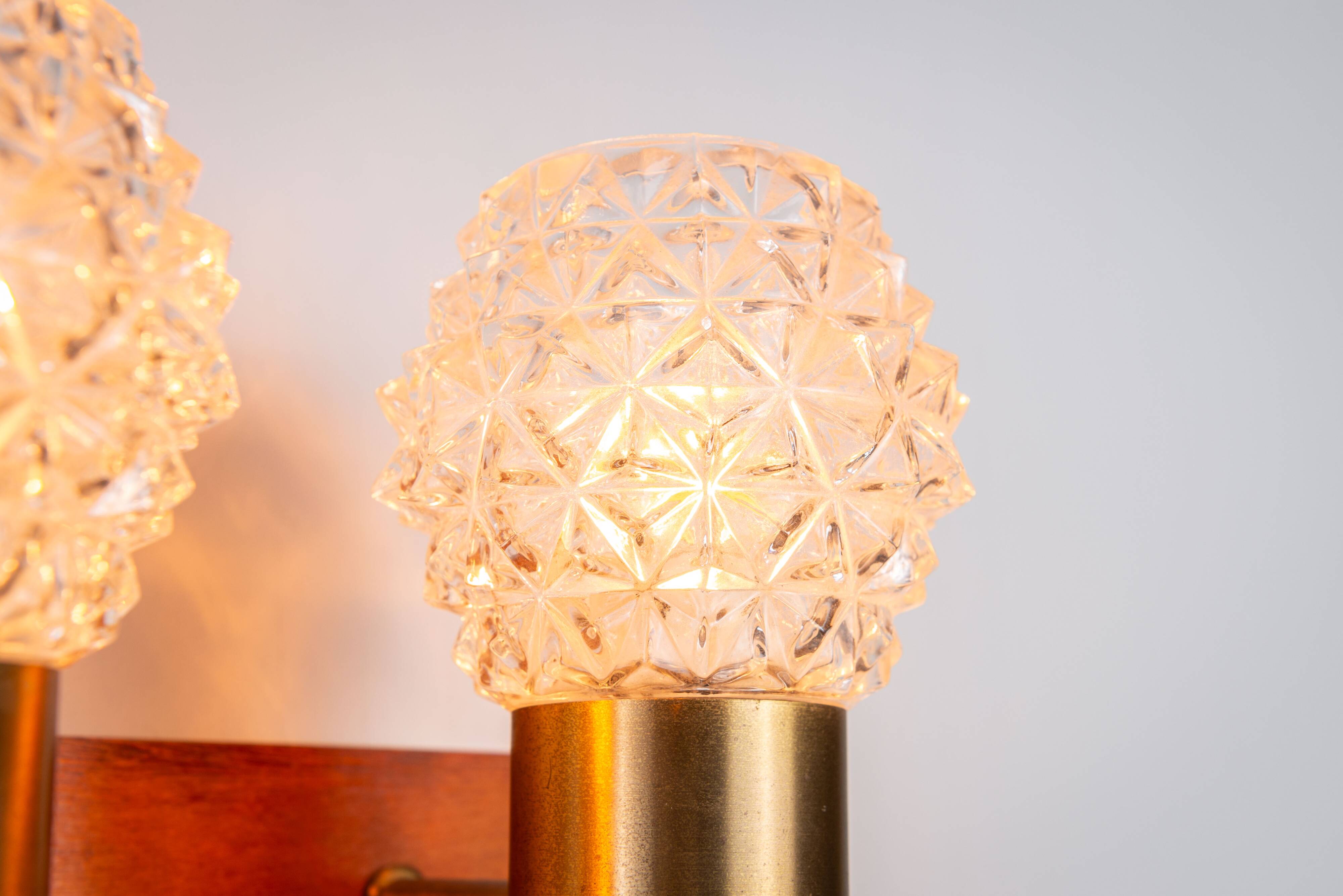 Pair of Swedish wall lamps with teak wood, brass and glass cup shade