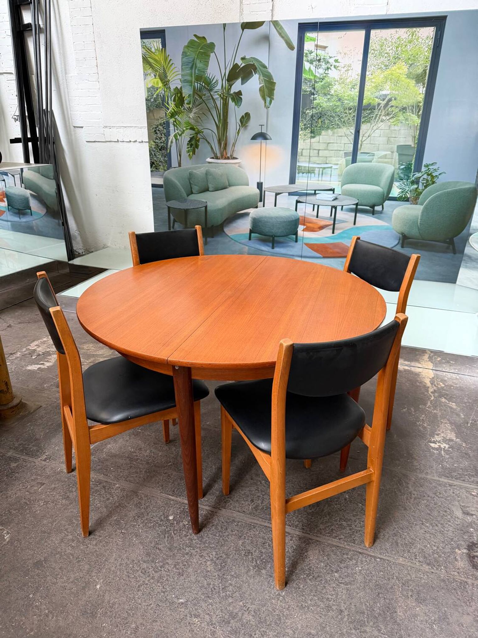 4 Scandinavian chairs in teak and black faux leather.