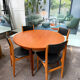 4 Scandinavian chairs in teak and black faux leather.