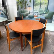 4 Scandinavian chairs in teak and black faux leather.