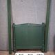 Directoire style bed in painted green wood.