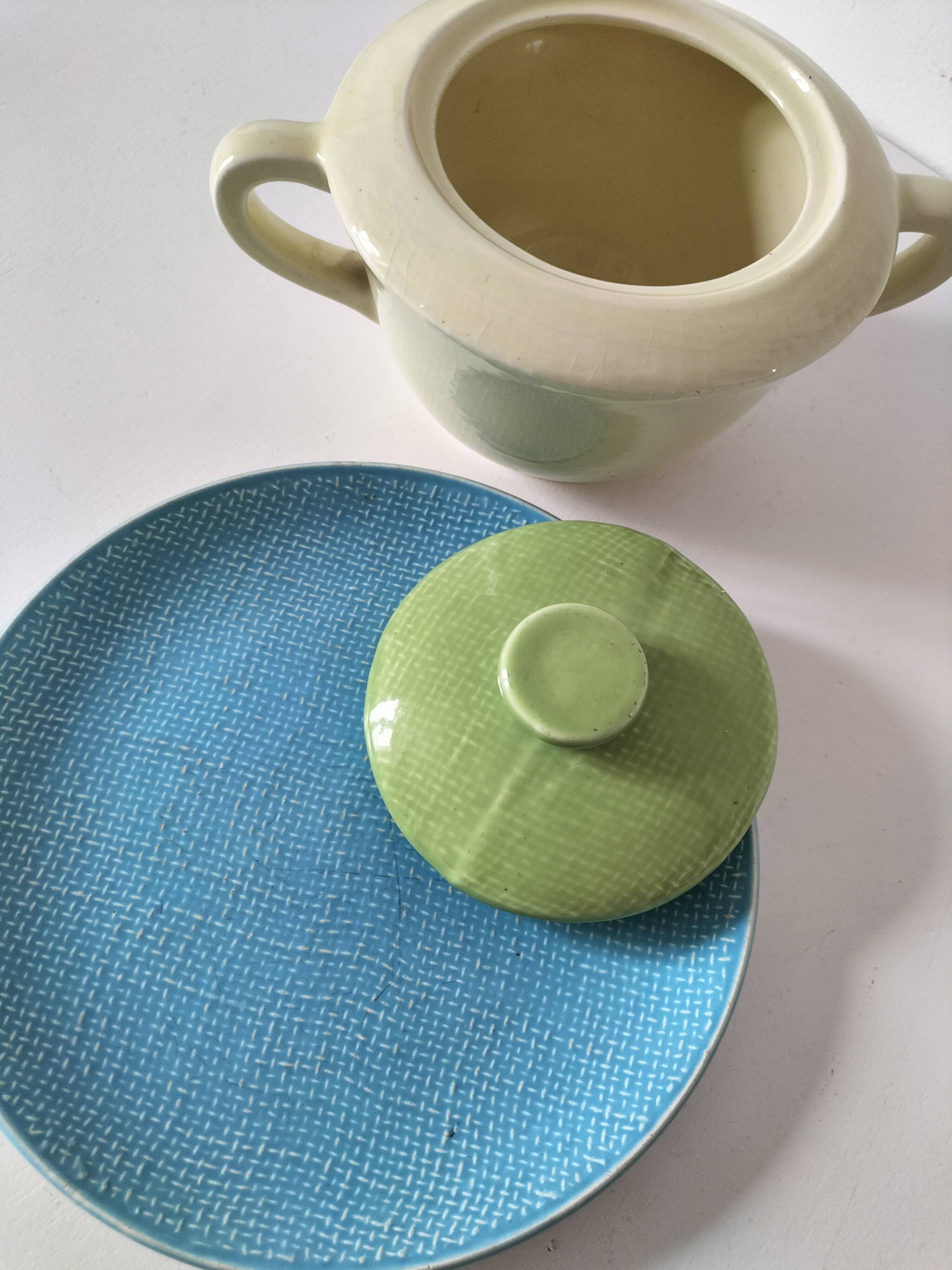 Two sugar bowls and a textured plate in turquoise and green Salins earthenware.