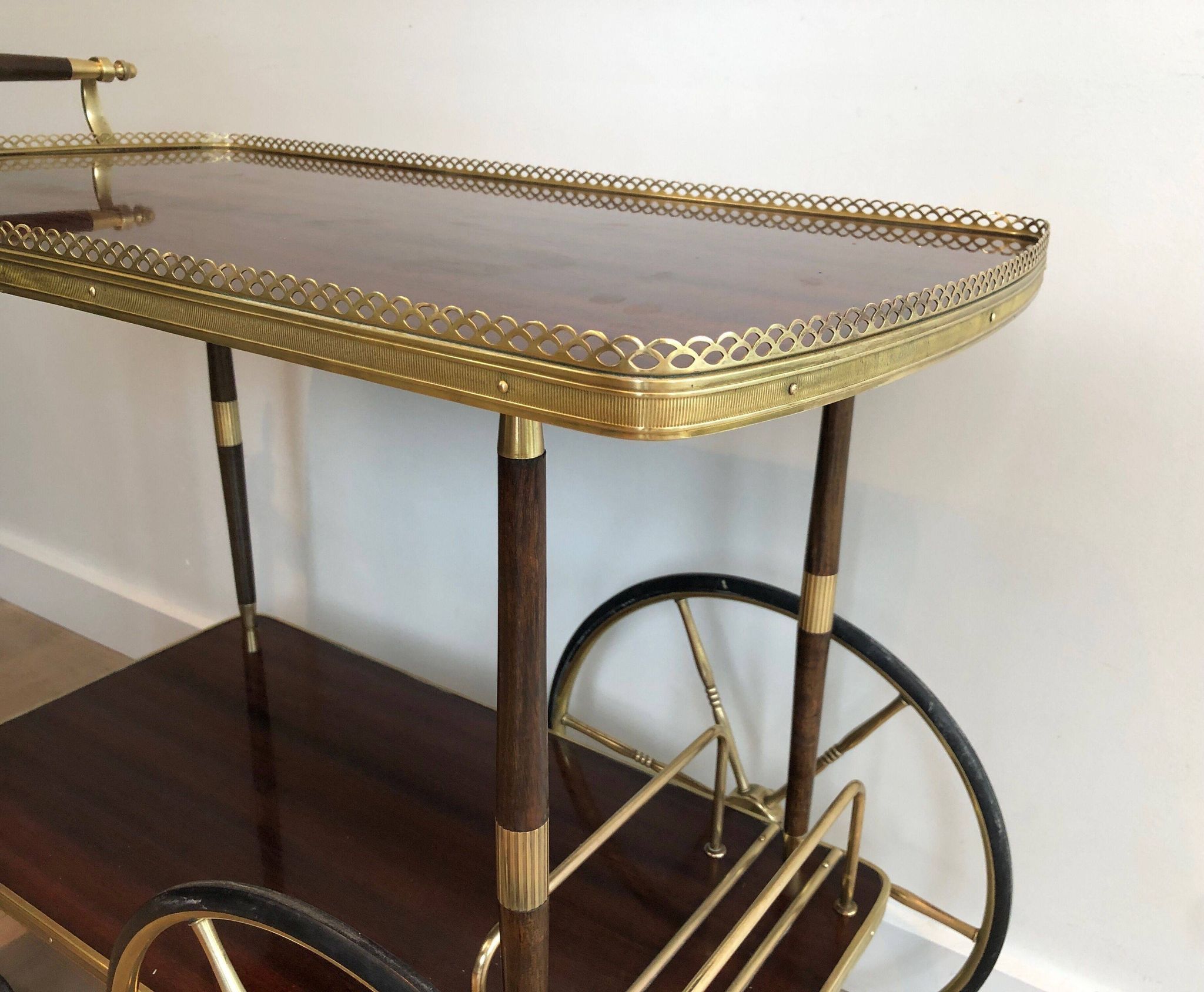 Mahogany and brass rolling table in the style of Maison Jansen.