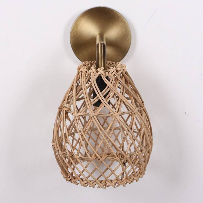 Golden bohemian wall lamp in woven rattan
