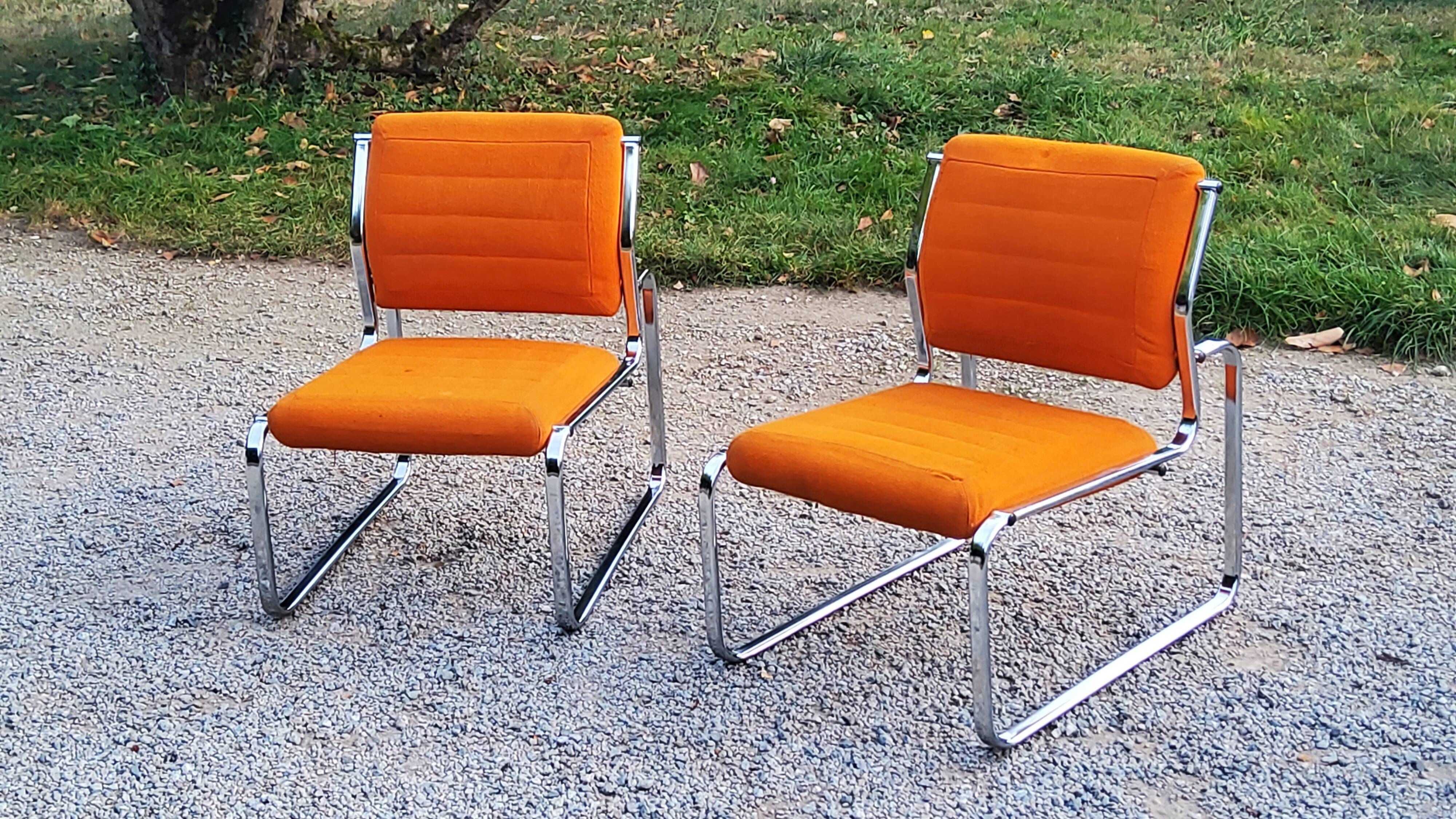 Pair of designer armchairs in orange fabrics and chrome tubes from the 70s