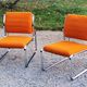 Pair of designer armchairs in orange fabrics and chrome tubes from the 70s