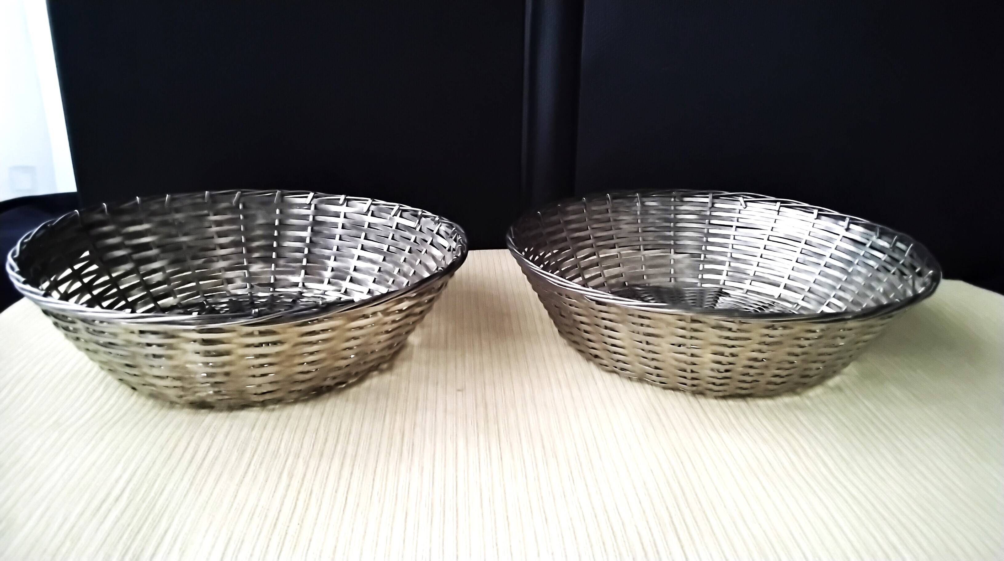 Pair of bread baskets, woven silver-plated wire baskets