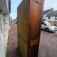 Vintage 1940s secretary desk with wooden curtains, storage, and shutters.
