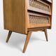 Vintage rattan chest of drawers with splayed legs from the 1950s.