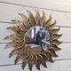 sun mirror with angel wings in golden patinated stucco