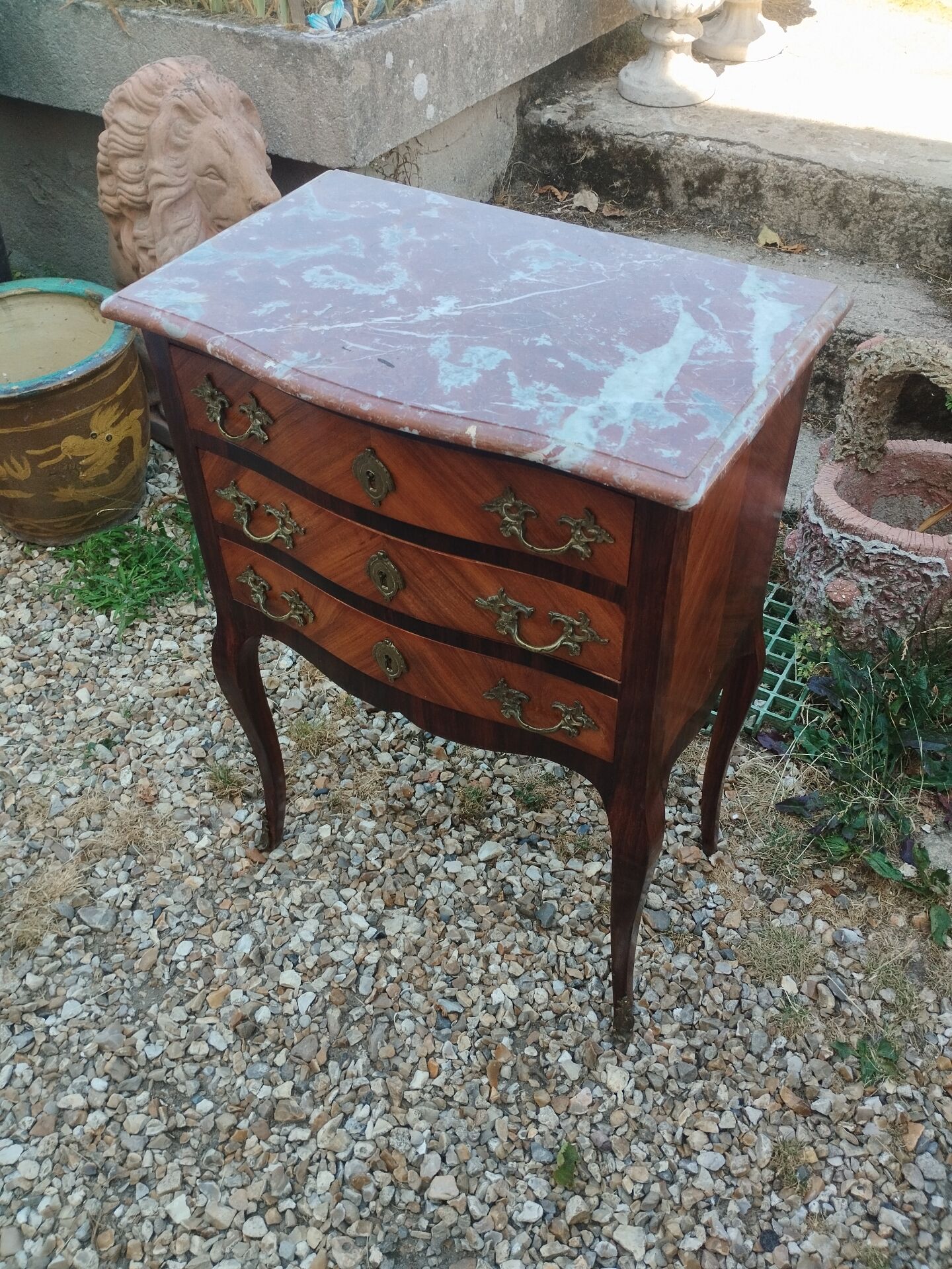 Antique marquetry commode with marble top in Louis XVI style.