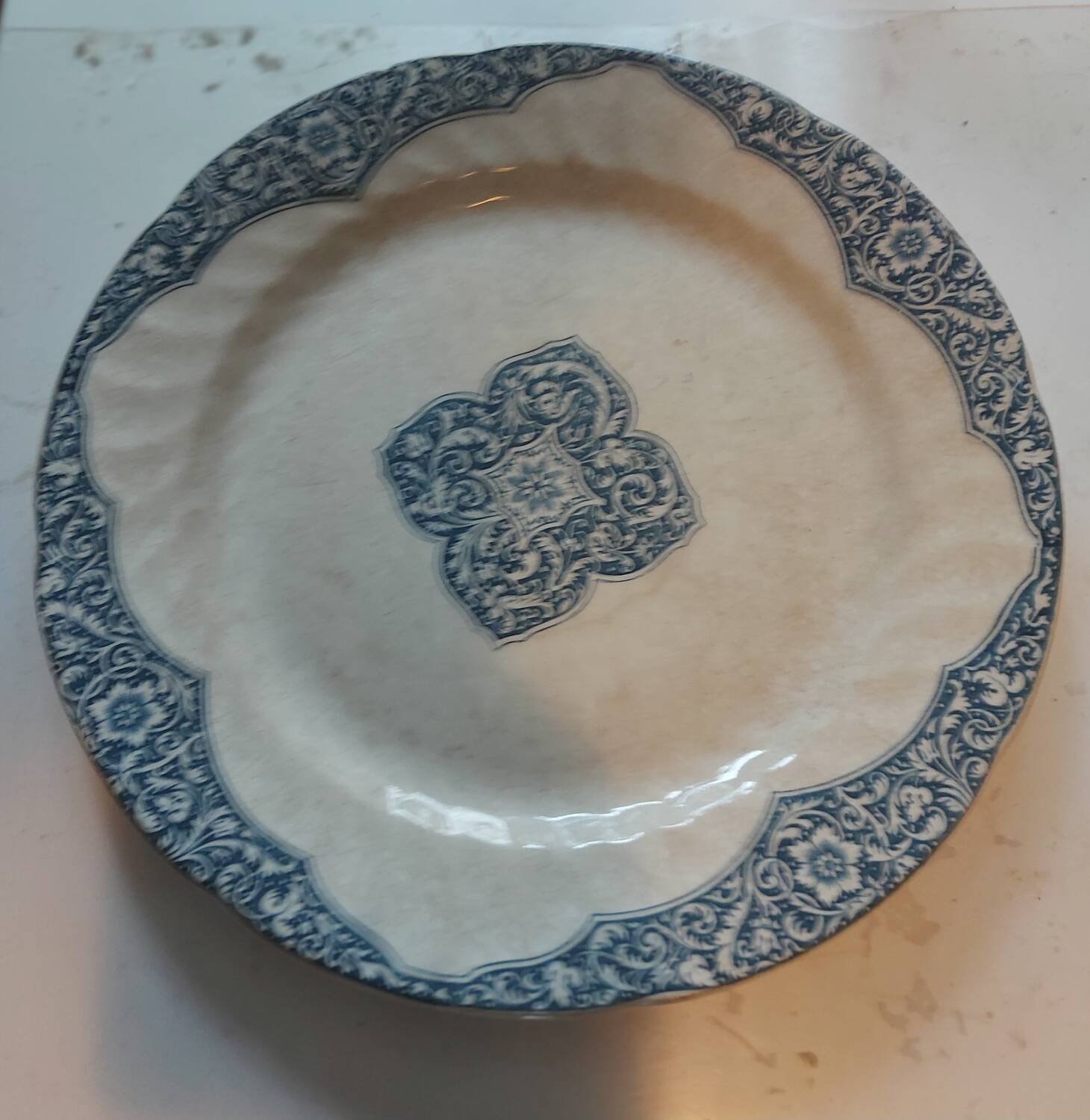 Two antique 19th-century plates, one flat and one deep, from Gien.