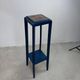Blue side table with a veined stone top and a low shelf in the Art Deco style.