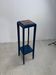 Blue side table with a veined stone top and a low shelf in the Art Deco style.
