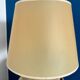 Ceramic table lamp representing women in hats on the sand.