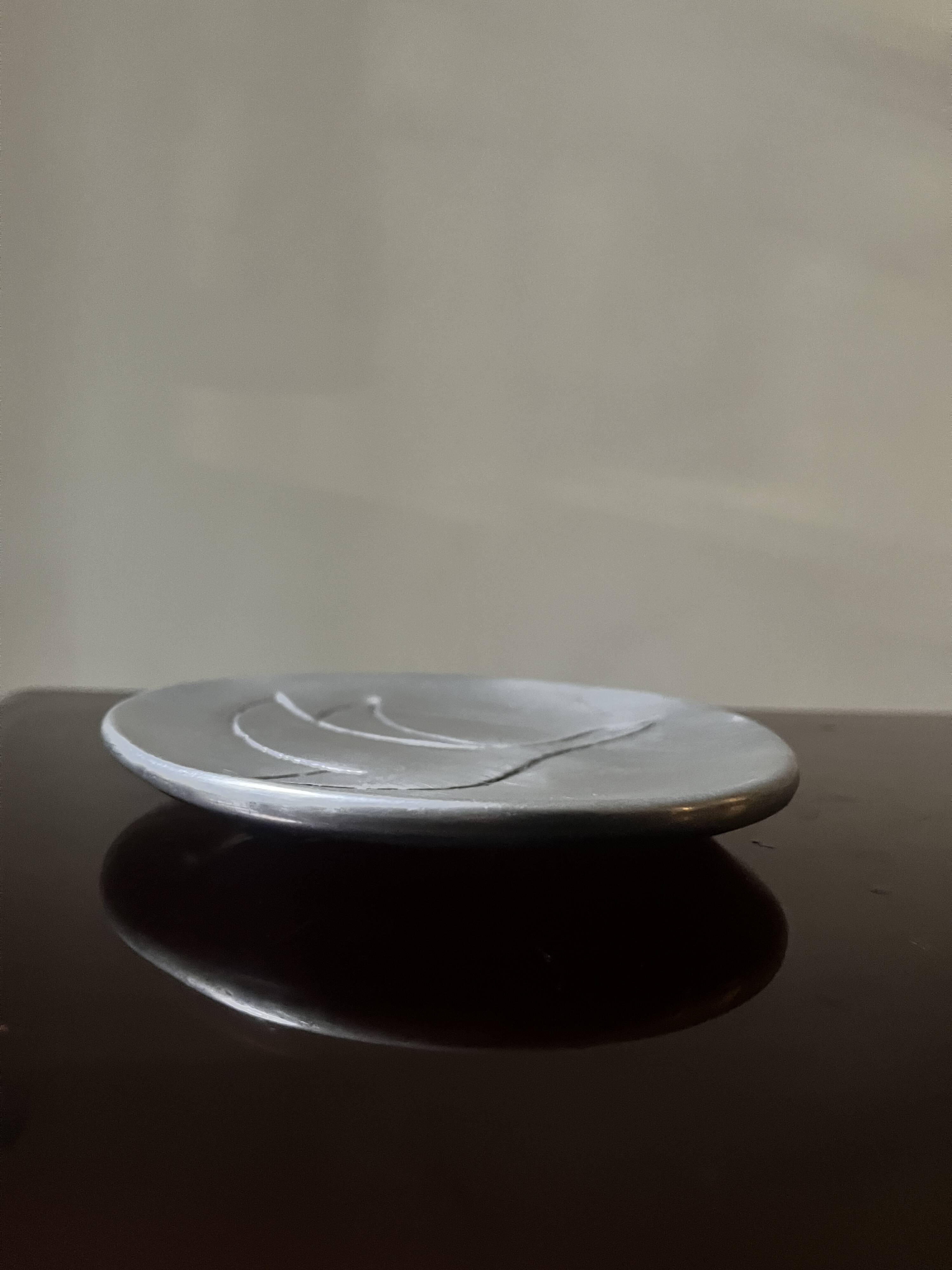 polished aluminum pocket emptier, signed and stamped in the mass