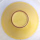 Brown ceramic salad and yellow ellipse
