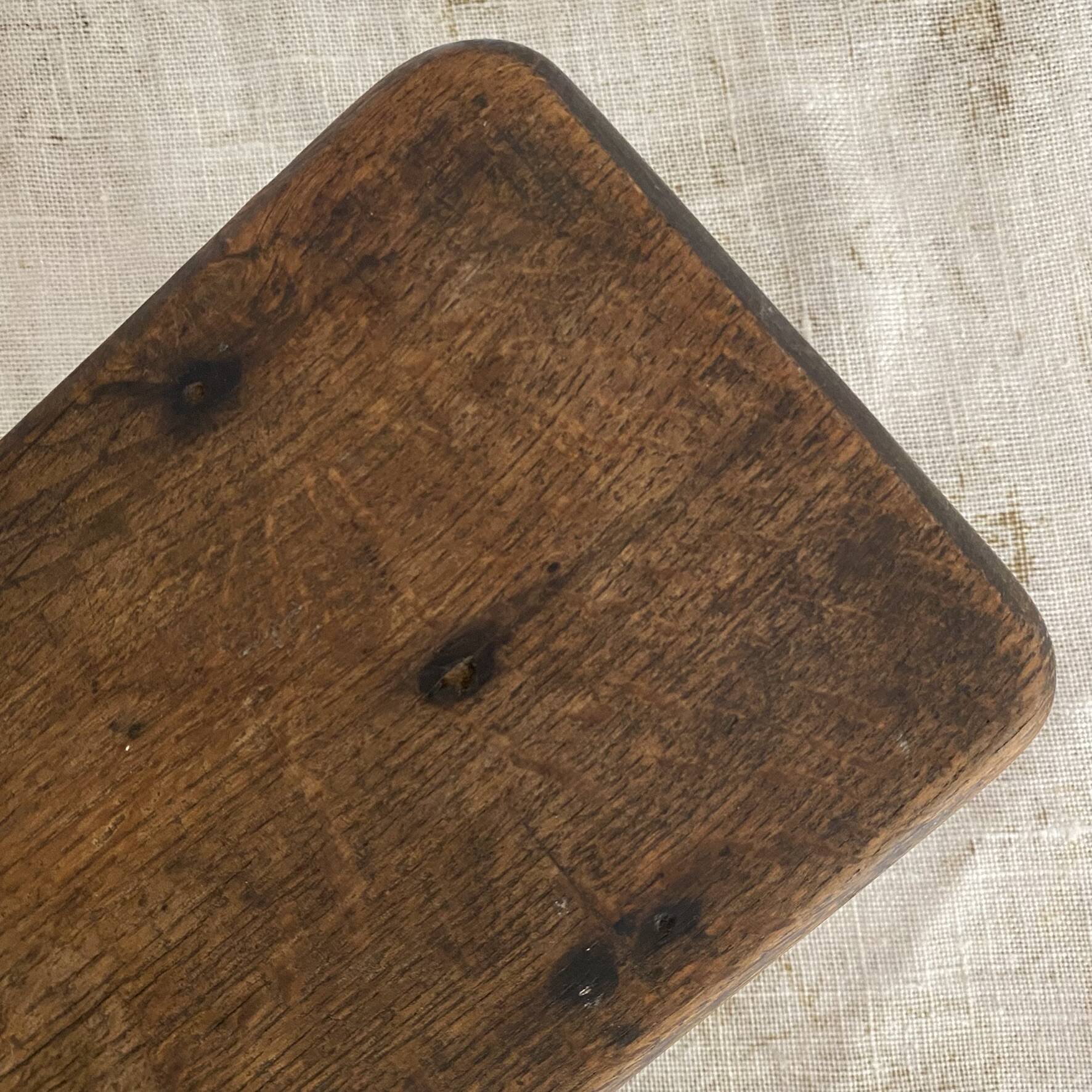 Old low stool made of solid wood