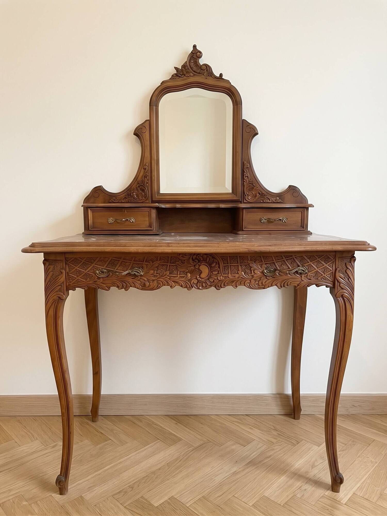 Antique carved wooden dressing table with marble and mirror.