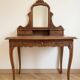 Antique carved wooden dressing table with marble and mirror.