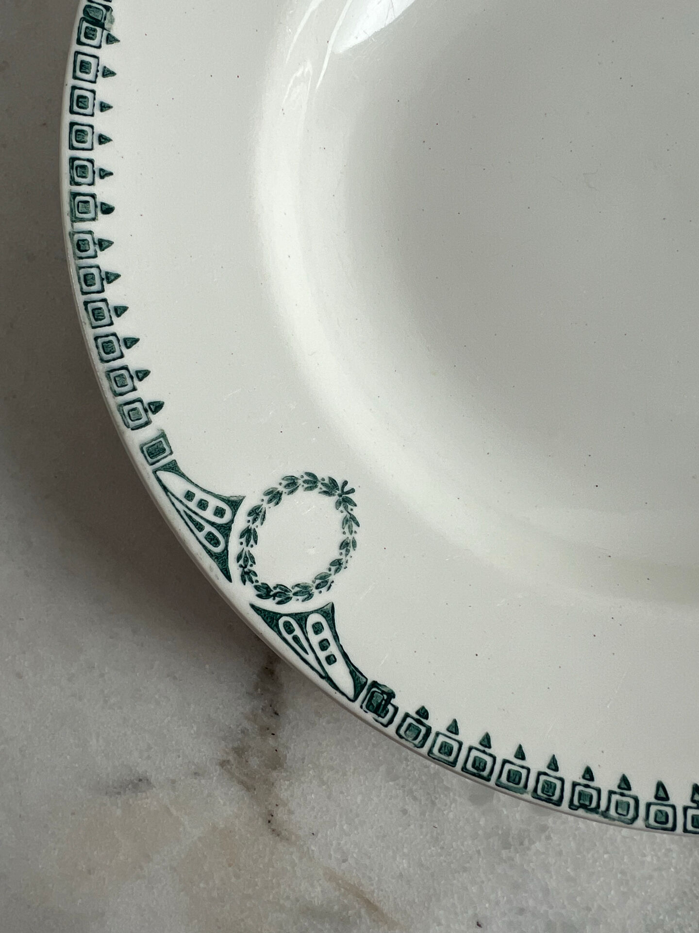 Céranord Saint Amand deep plate with green crown decoration.