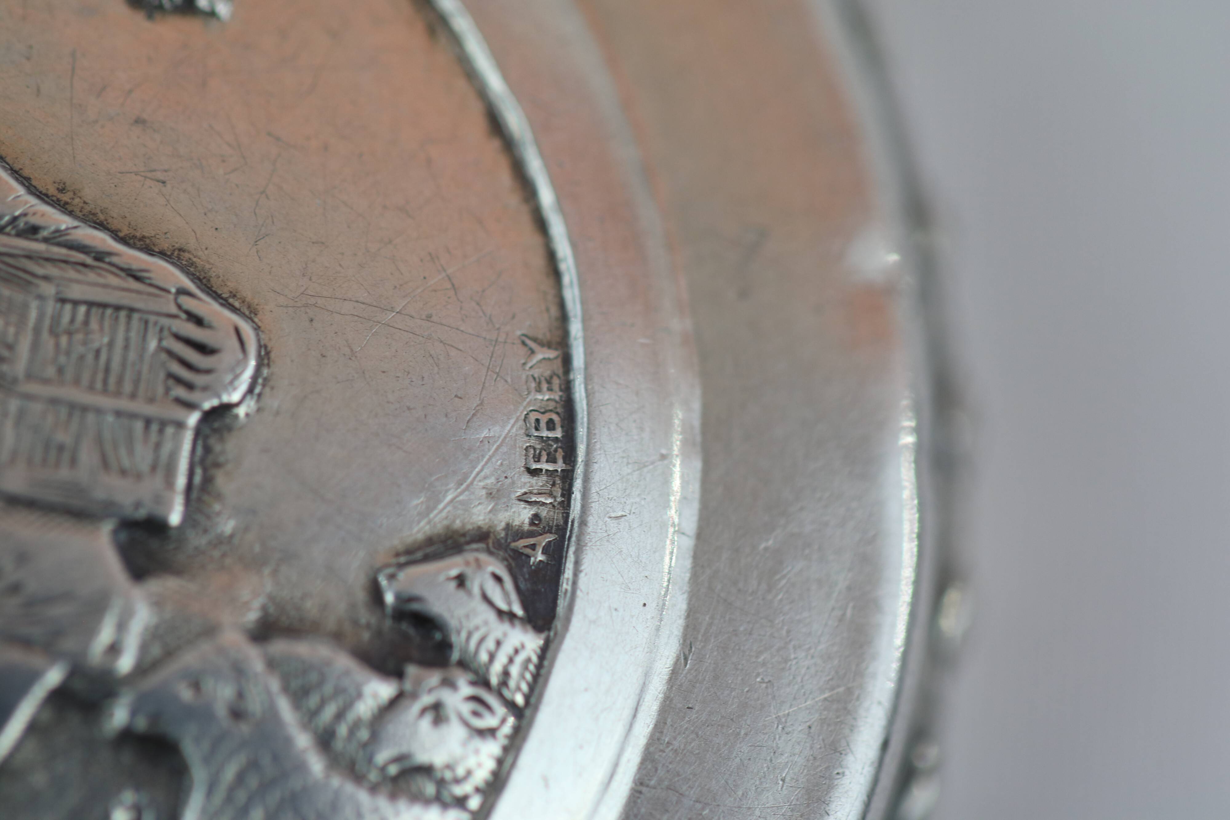 Small round box with silver pills